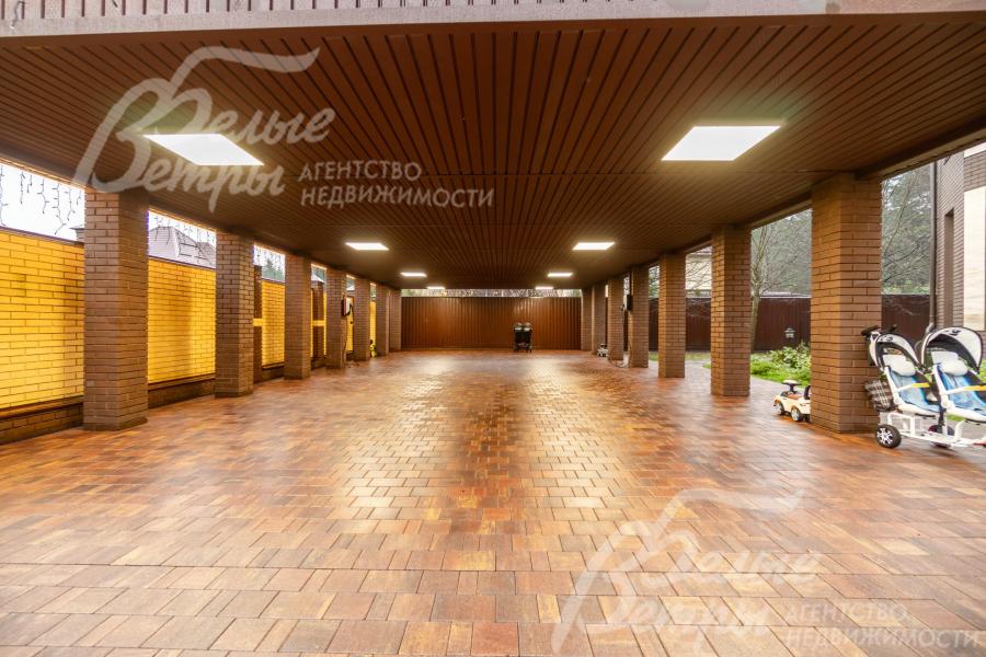 Парковка под навесом для 6 автомобилей - на кирпичных столбах, построена в едином архитектурном стиле, есть зарядные станции для электромобилей