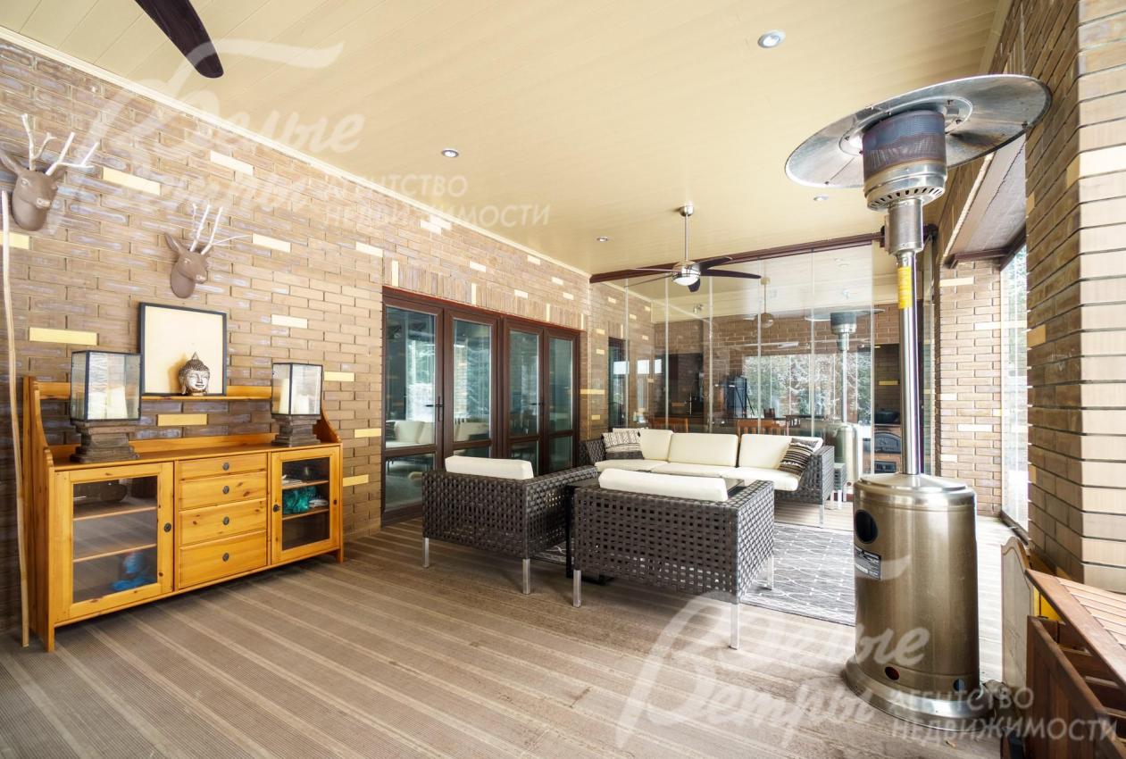 Из кухни-столовой выход на крытую веранду 57 кв.м с раздвижным безрамным остеклением на три стороны