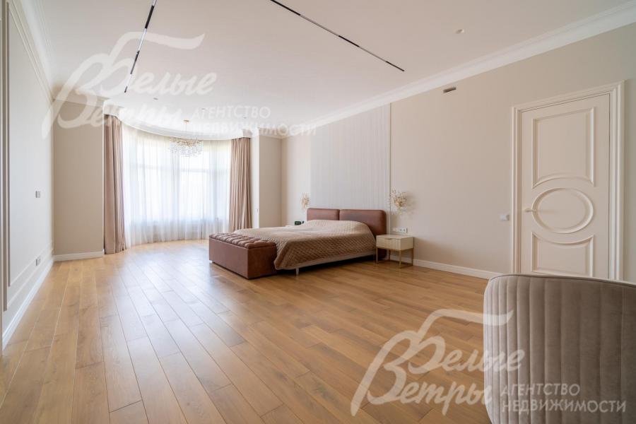 В просторной мастер-спальне установлен спальный гарнитур и рабочее место