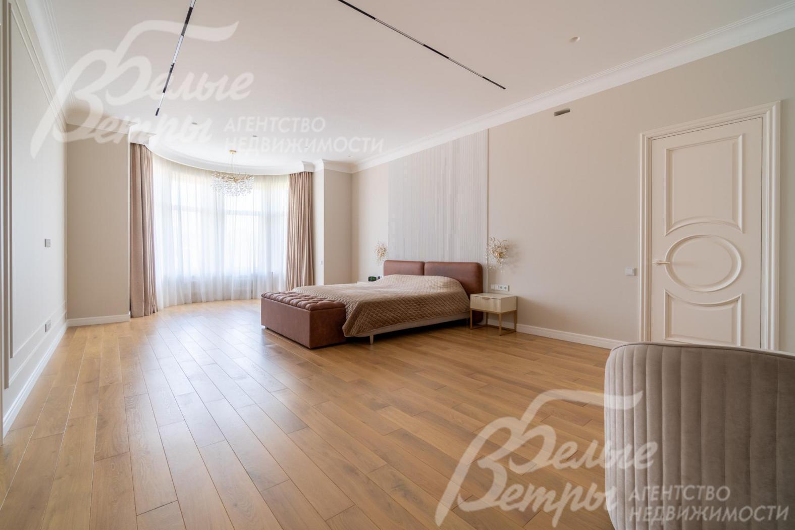 В просторной мастер-спальне установлен спальный гарнитур и рабочее место