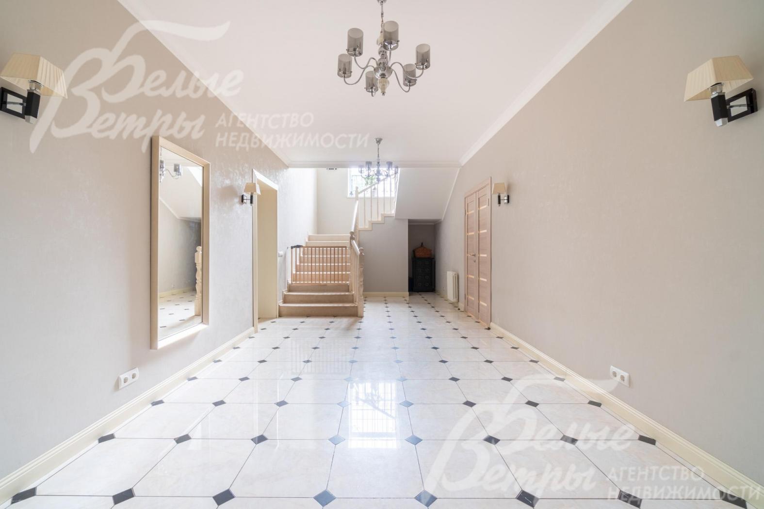 Светлый просторный холл на первом этаже, на полу - керамогранит с водяным подогревом