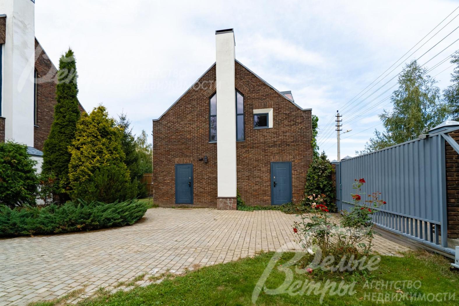 Участок огорожен деревянным забором на кирпичных столбах