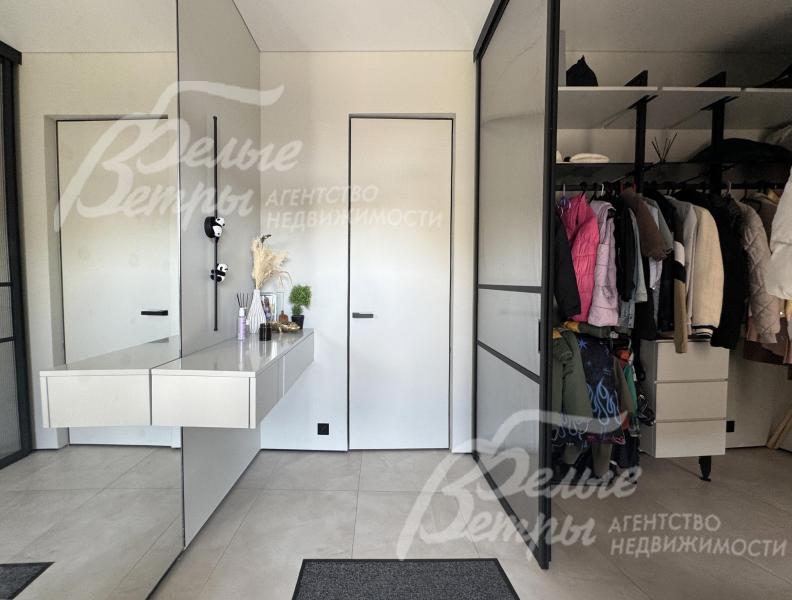 Прихожая дома: справа - просторная гардеробная, слева - зеркало во всю стену