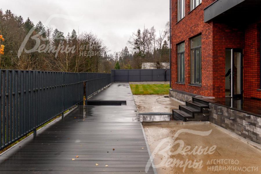 Выход на террасу из кухни, ниже расположена видовая площадка с панорамой на пруд и природу